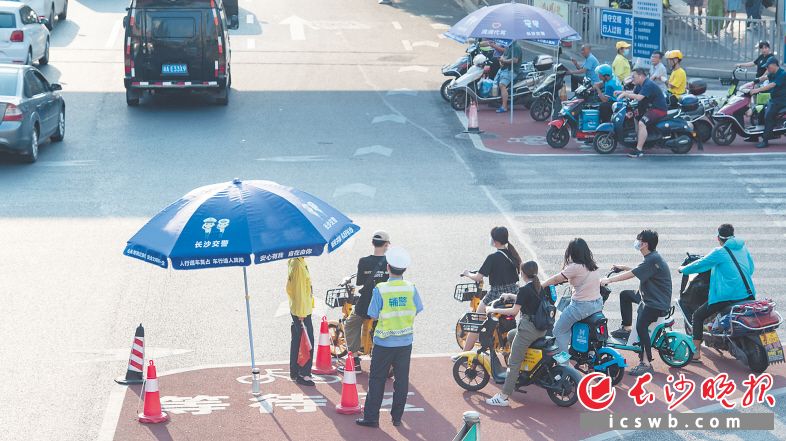 在营盘路蔡锷路口，每天都有志愿者、交警执勤，倡导市民们有序等待红灯，文明礼让。长沙晚报全媒体记者 邹麟 摄