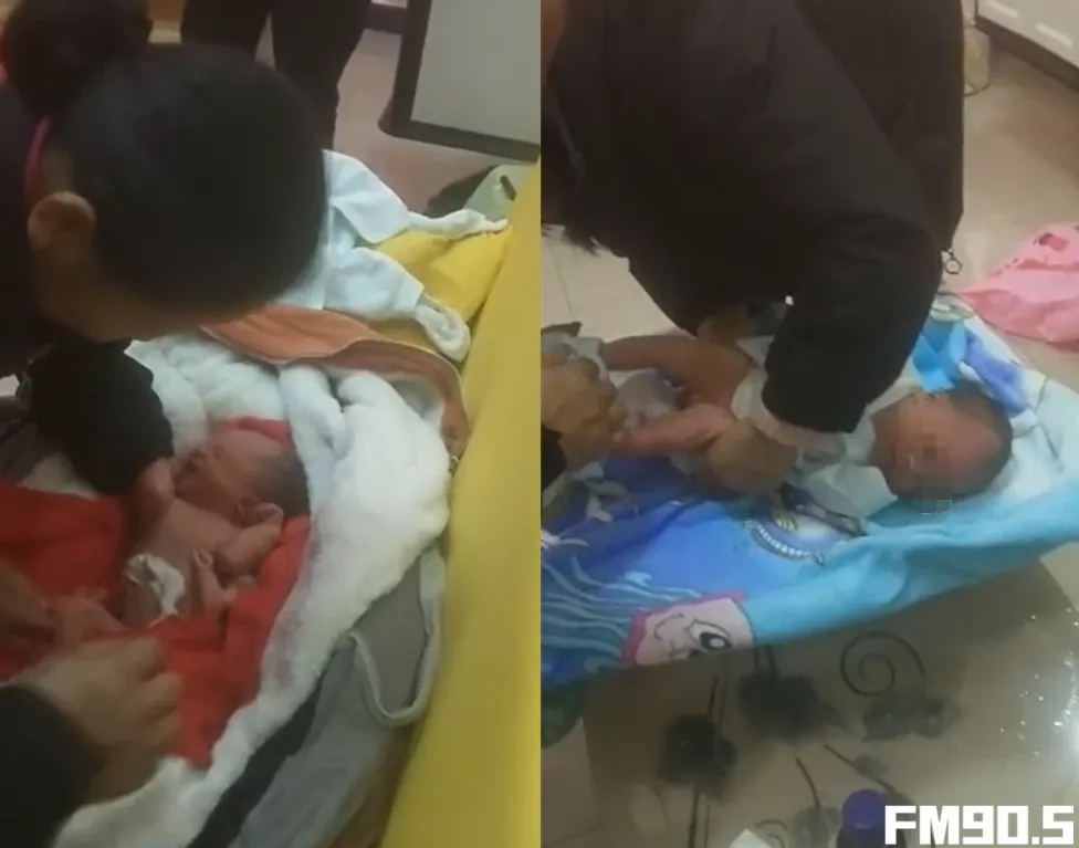 工作人员为新生儿清理、穿衣。