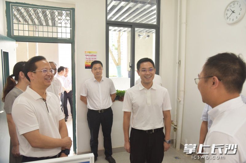 谢伟峰（中）走进教师办公室与教师交流。长沙晚报通讯员 荣庭芳 摄