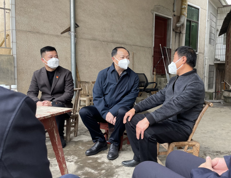 郑建新与困难群众亲切交谈。