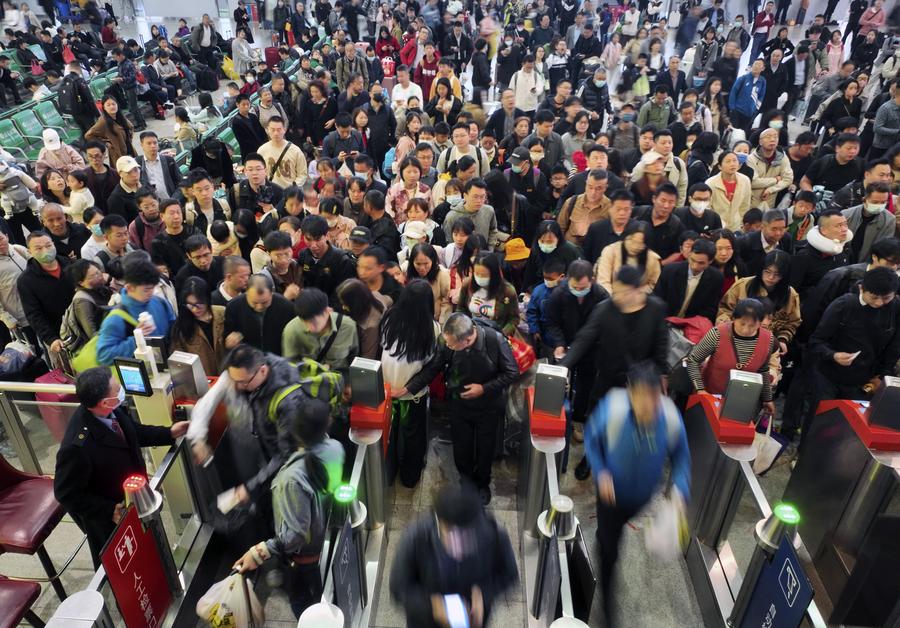 A drone photo taken on April 6, 2024 shows travelers going through automated gateways at the departure hall of Hengyang East Station in Hengyang, central China's Hunan Province. (Photo by Cao Zhengping/Xinhua)