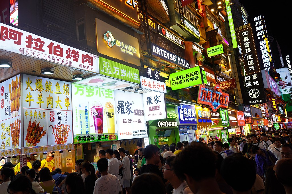 Visitors walk on a gourmet street in Changsha, Central China's Hunan province, Aug 2, 2024. [Photo/VCG]
