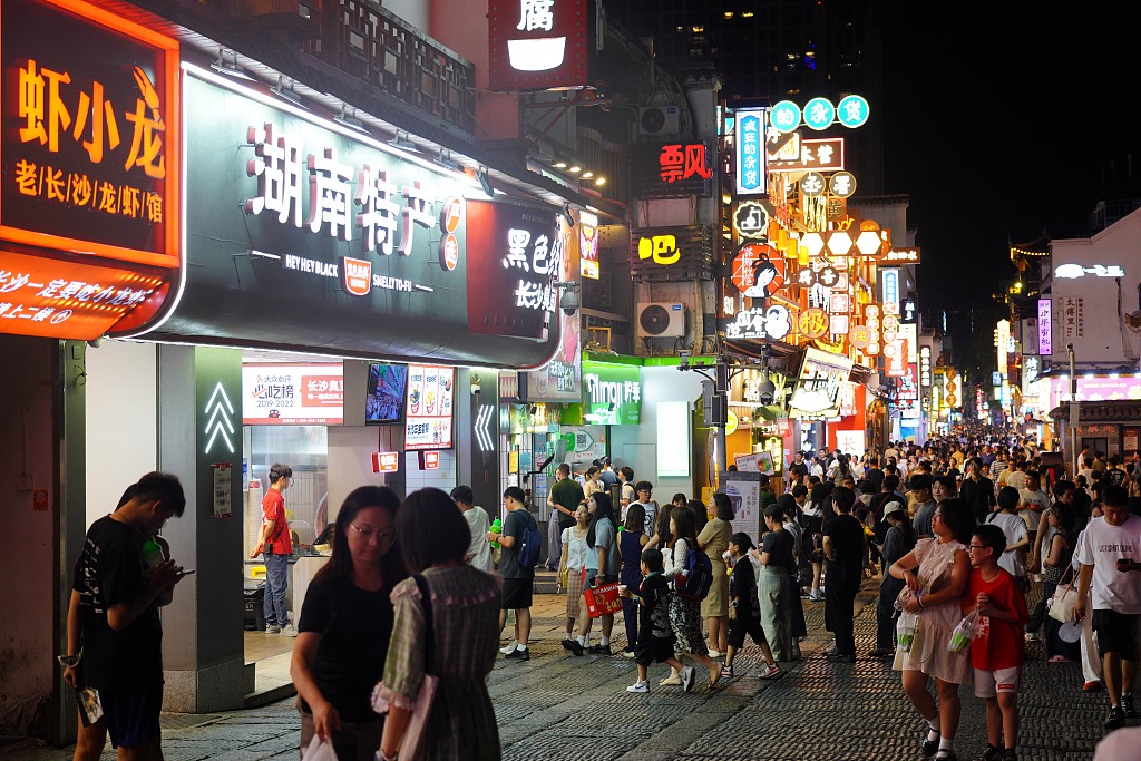 People visit a gourmet street in Changsha, Hunan province, Aug 2, 2024. [Photo/VCG]
