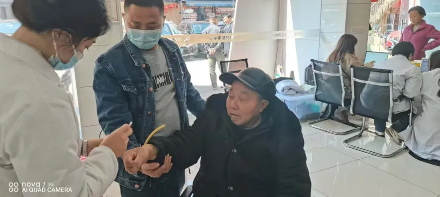 周智勇守护年老居民就医治疗。 周智勇守护年老居民就医治疗。