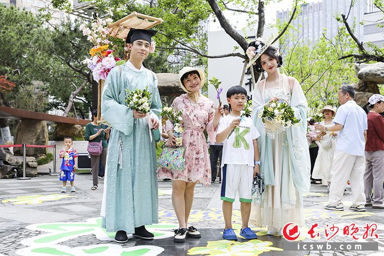 5月16日，在天心阁活动现场，两名游客开心地收到了“送花使者”送上的栀子花。长沙晚报全媒体记者 董阳 摄